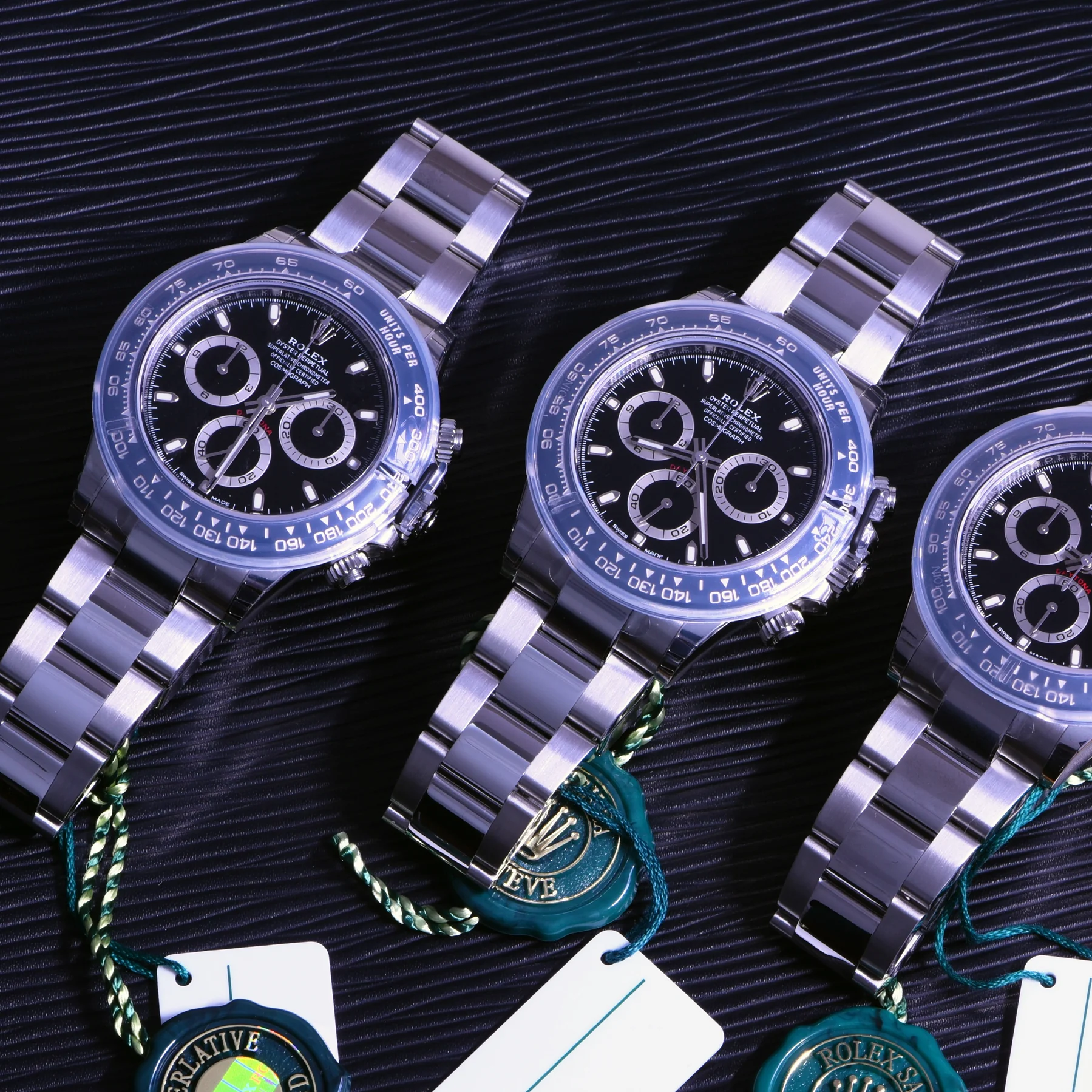Three Rolex Daytona watches with certification tags